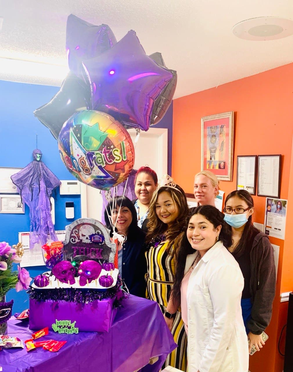 Halloween-themed celebration with congratulatory star balloons and the team