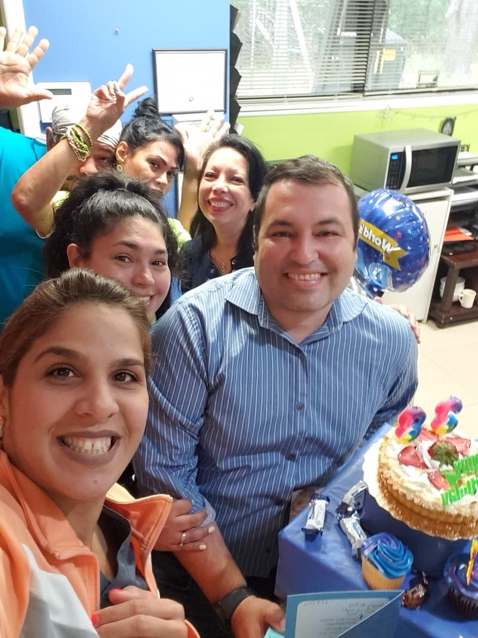 Selfie of the team with Andy at a celebration with cake